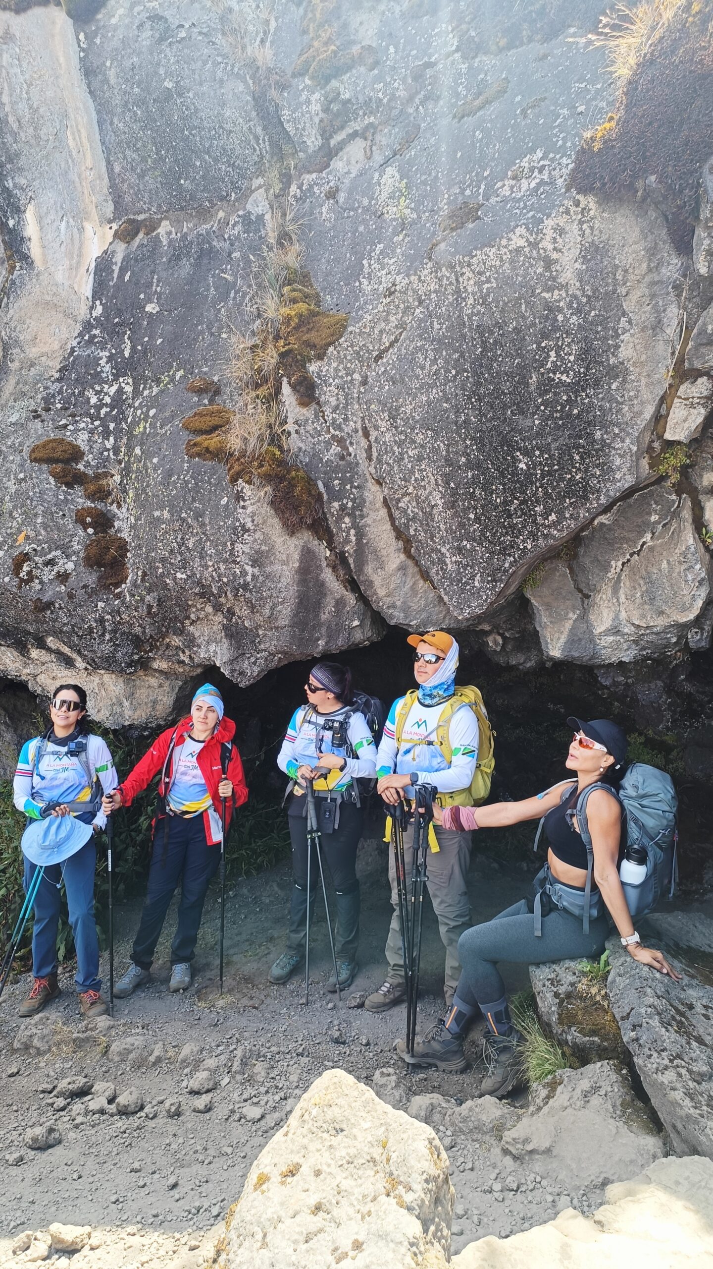 a group of climbers hiking Kilimanjaro with backpacks and poles